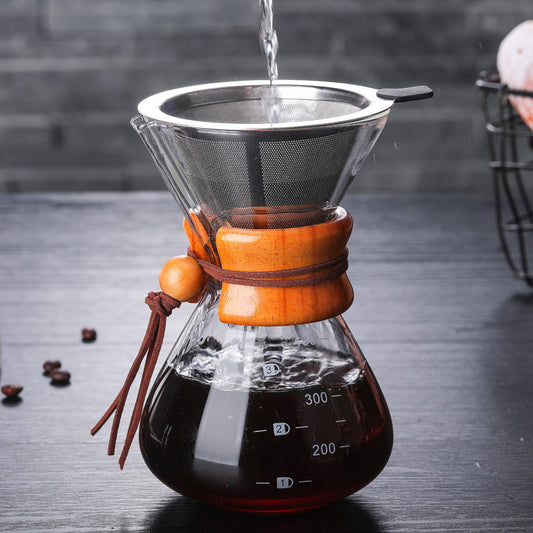 Pouring hot water into a Chemex glass coffee maker for brewing coffee.
